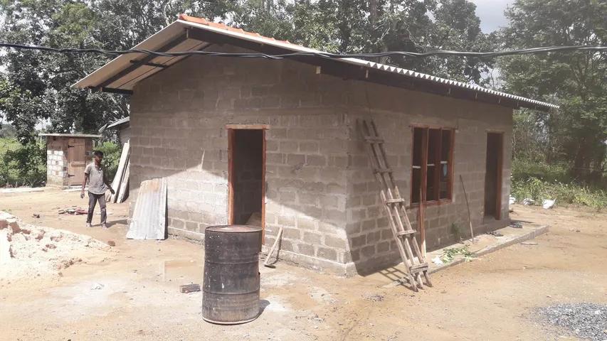 House 1 — family outside their new home
